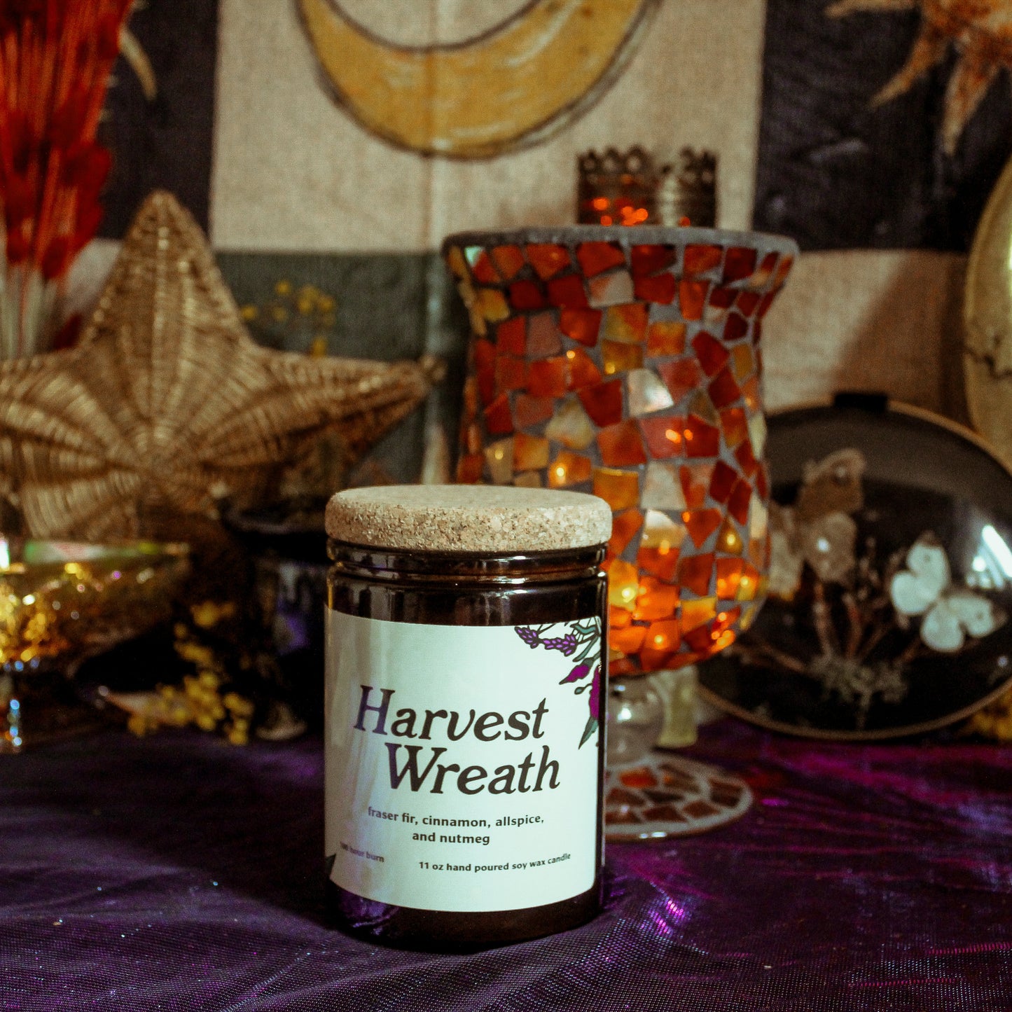 Jar labeled 'Harvest Wreath' on a table with decorative items in the background