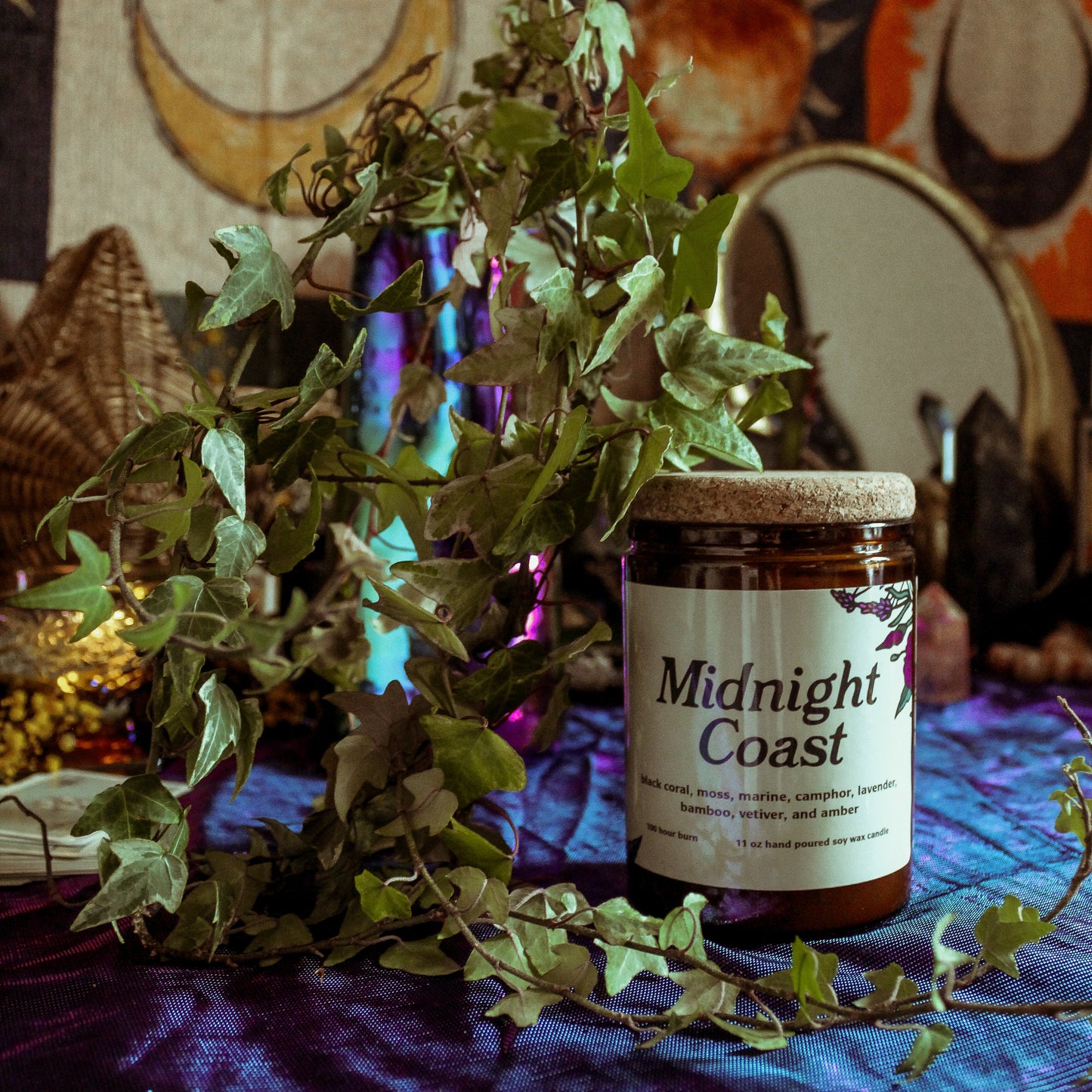 Jar labeled 'Midnight Coast' on a table with decorative background