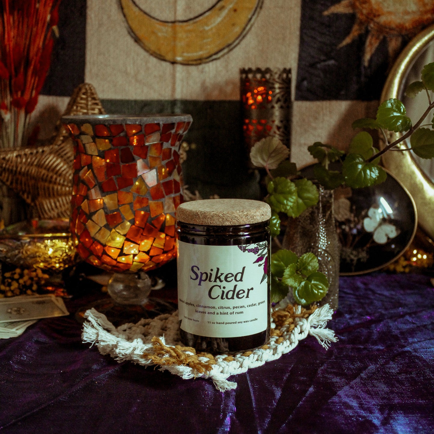 Jar of 'Spiked Cider' on a decorative table with mystical decor