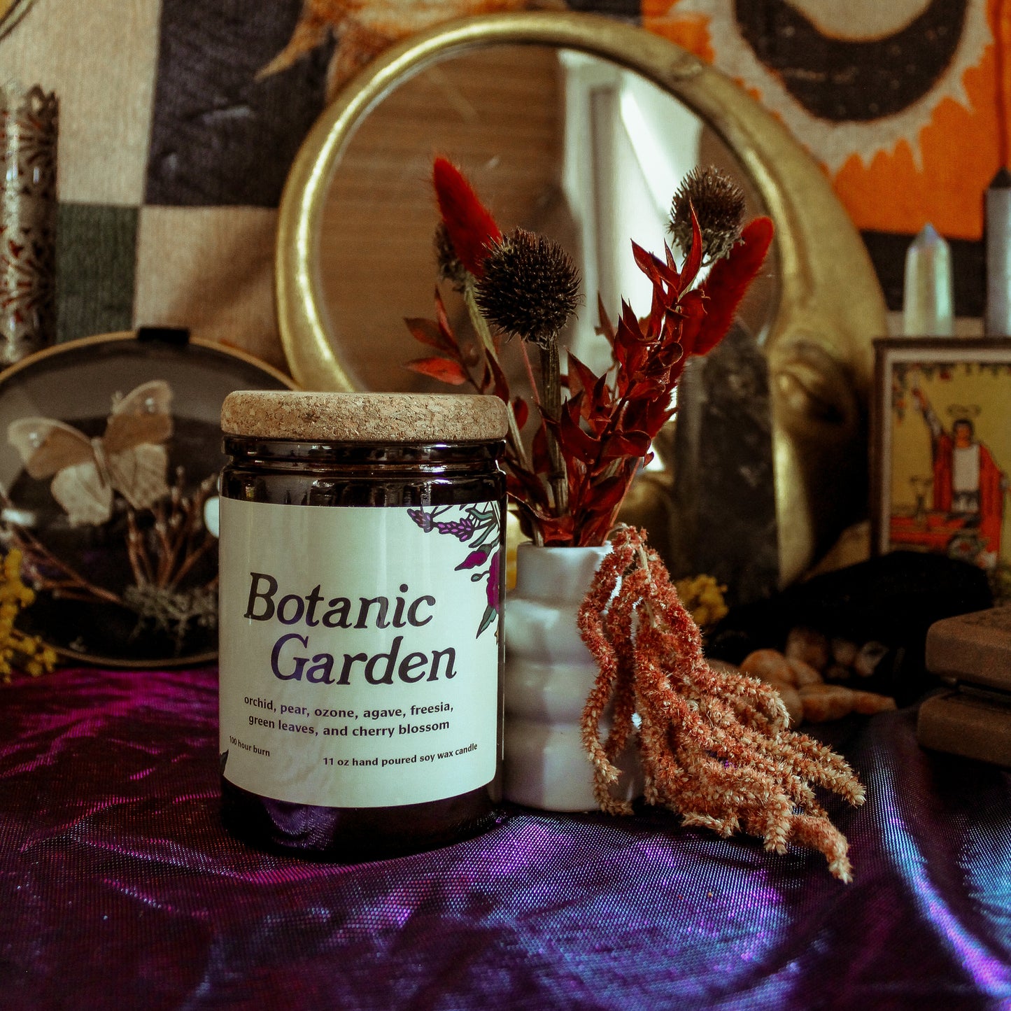 Jar labeled 'Botanic Garden' on a table with decorative items and wall art.