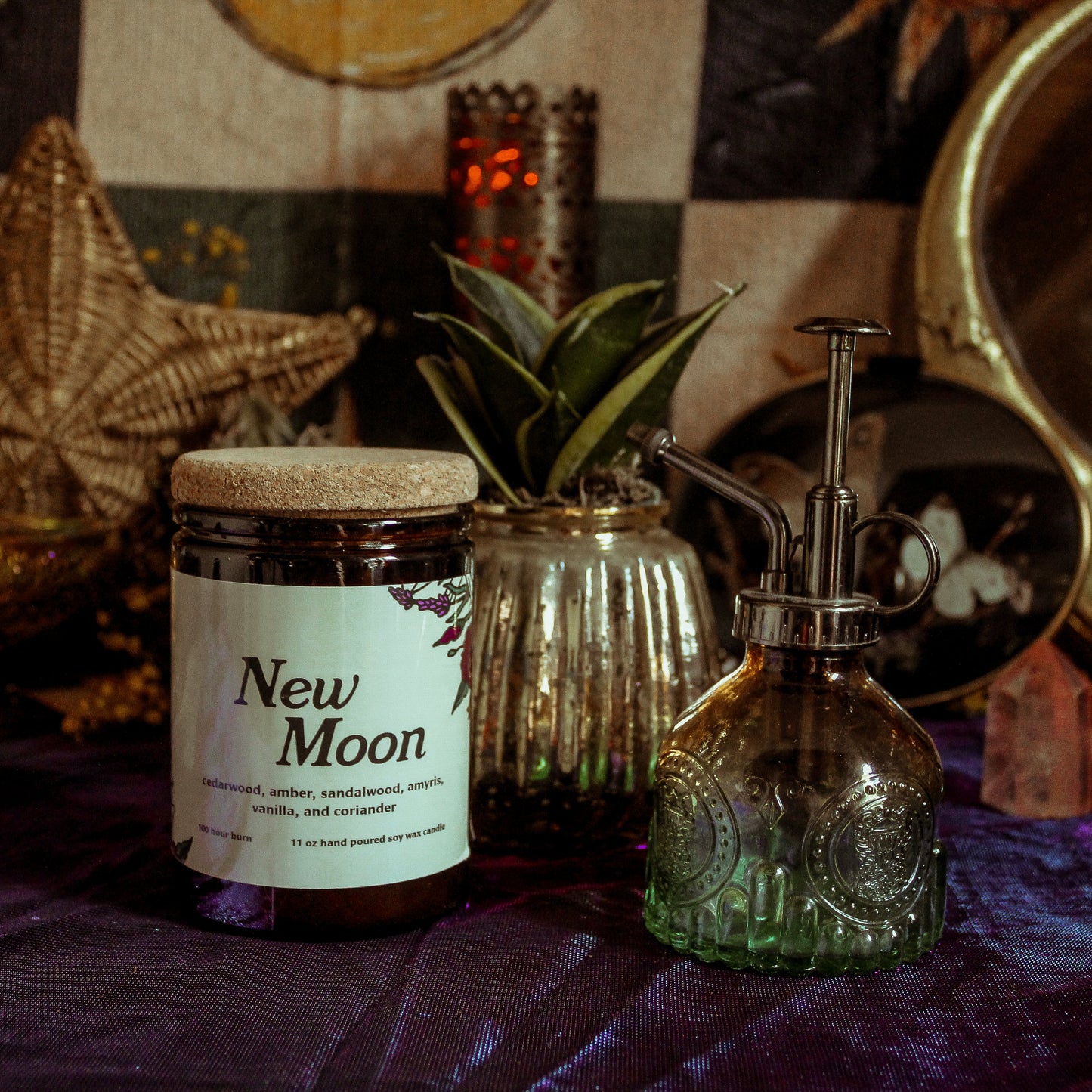 Bottle labeled 'New Moon' on a table with decorative items