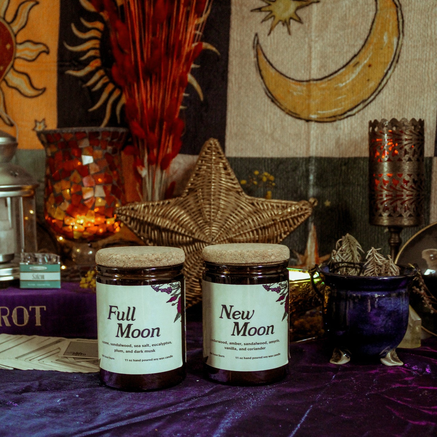 Two jars labeled 'Full Moon' and 'New Moon' on a purple fabric with celestial decorations in the background.