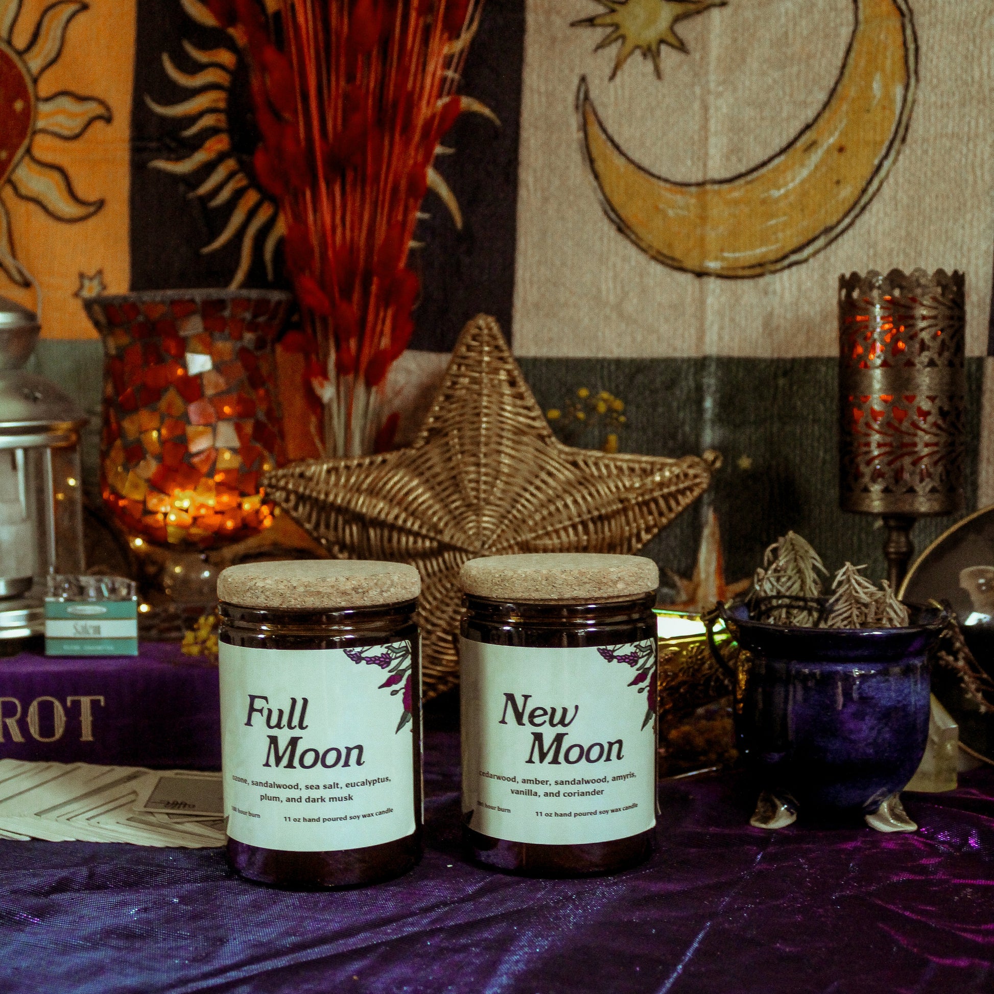 Two jars labeled 'Full Moon' and 'New Moon' on a purple fabric with celestial decorations in the background.
