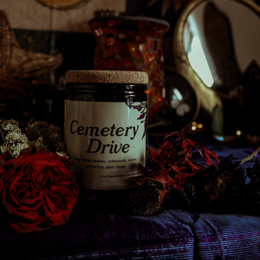 Jar labeled 'Cemetery Drive' with decorative elements in the background