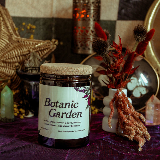 Jar labeled 'Botanic Garden' on a purple surface with decorative items in the background