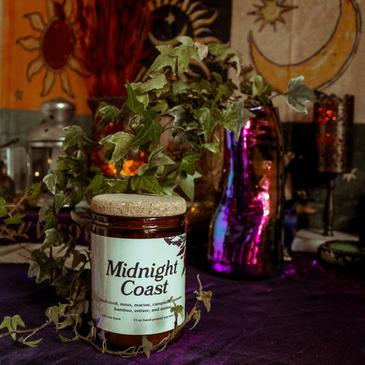 Jar labeled 'Midnight Coast' on a table with decorative background