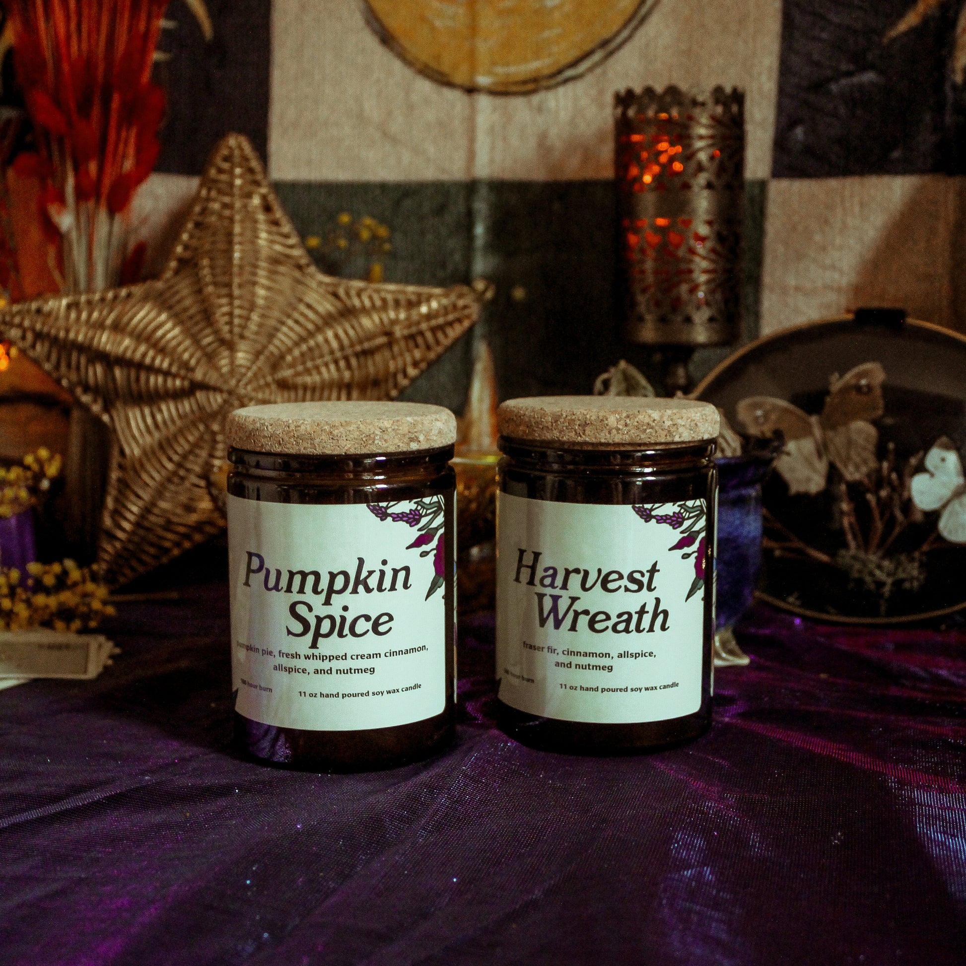 Two jars labeled 'Pumpkin Spice' and 'Harvest Wreath' on a purple surface with a star and moon decoration in the background.