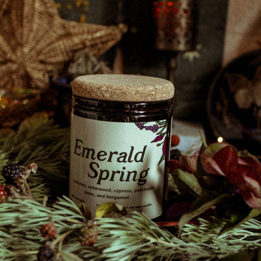 Jar of 'Emerald Spring' candle with decorative background