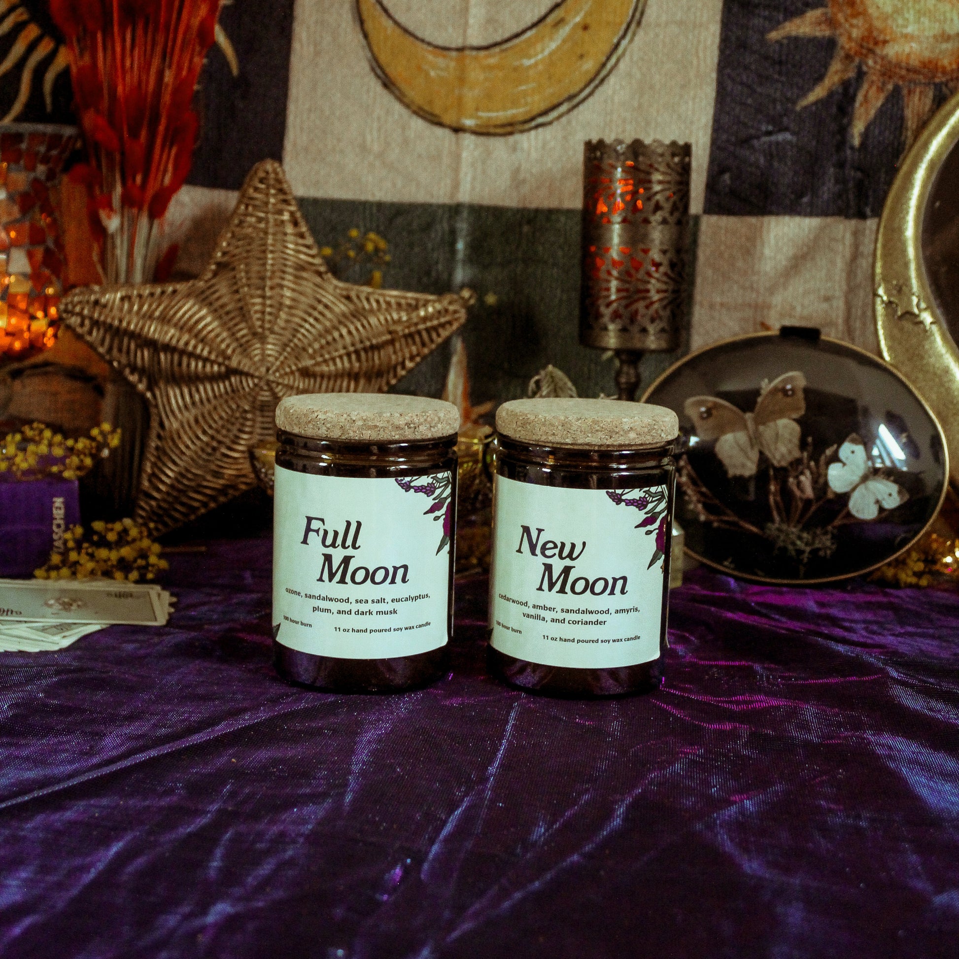 Two candles labeled 'Full Moon' and 'New Moon' on a purple surface with celestial decorations.
