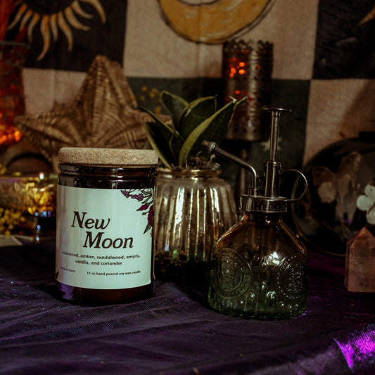Jar labeled 'New Moon' on a table with mystical decor